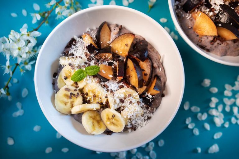 Ripe banana and coconut pudding garnished with unsweetened coconut flakes
