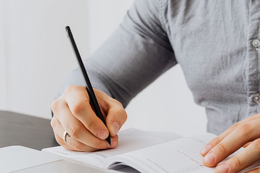 Hand recording notes in a food and symptom journal