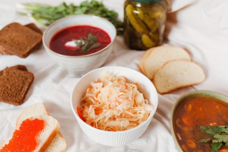 Assorted fermented vegetables in glass jars with brine