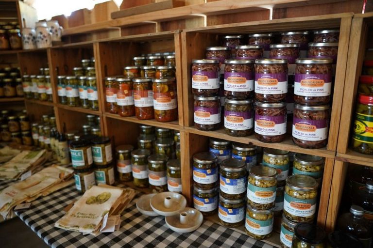Fermented vegetables in glass jars on a pantry shelf
