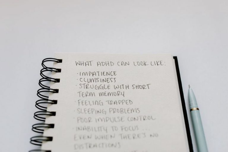 Handwritten food and symptom diary on a wooden table