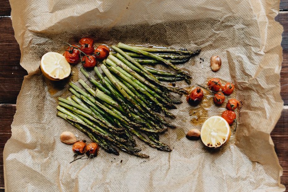 Fresh vegetables and grilled chicken arranged on a cutting board