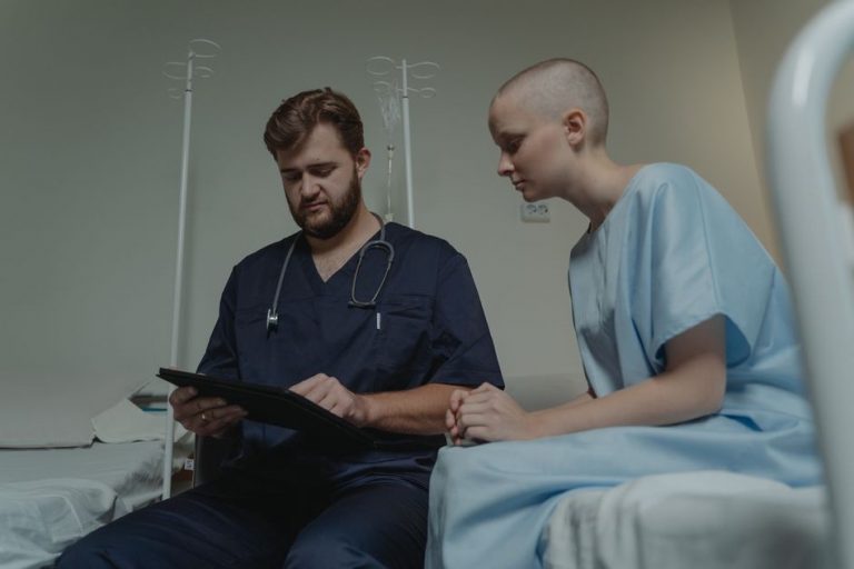 woman showing her symptom log to a physician at a wooden desk