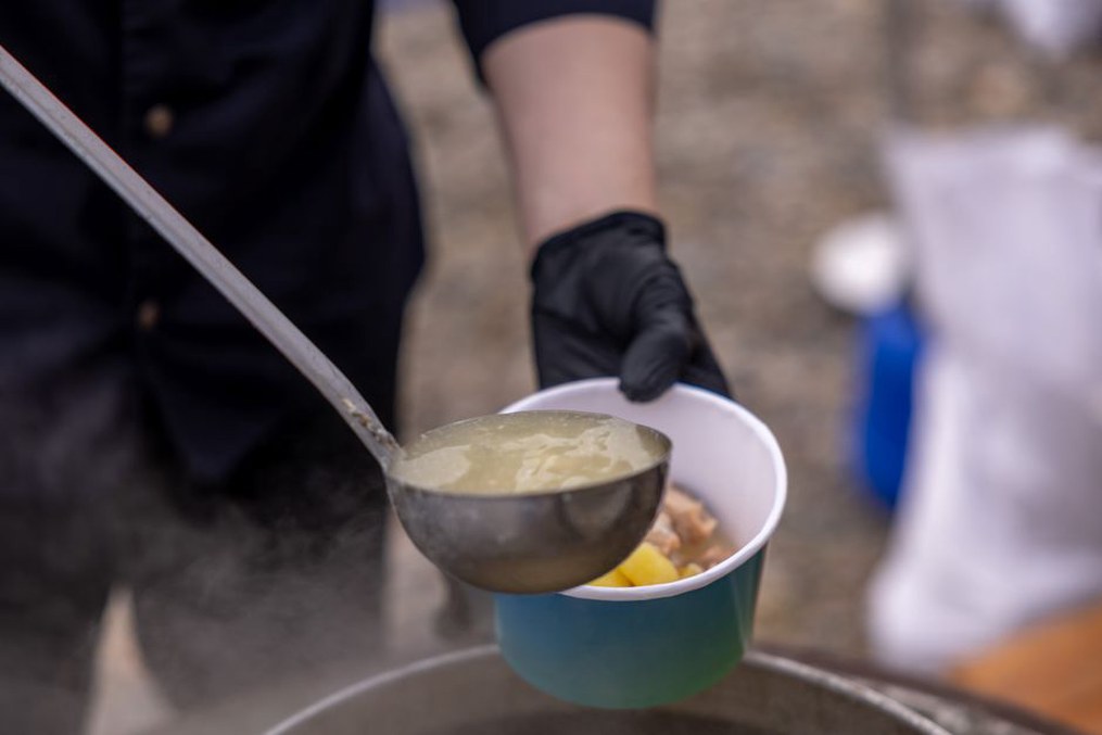 Pouring bone broth into a serving bowl