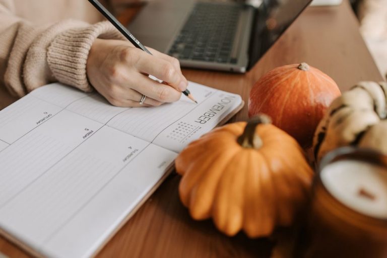 handwritten meal log on notebook next to fresh vegetables