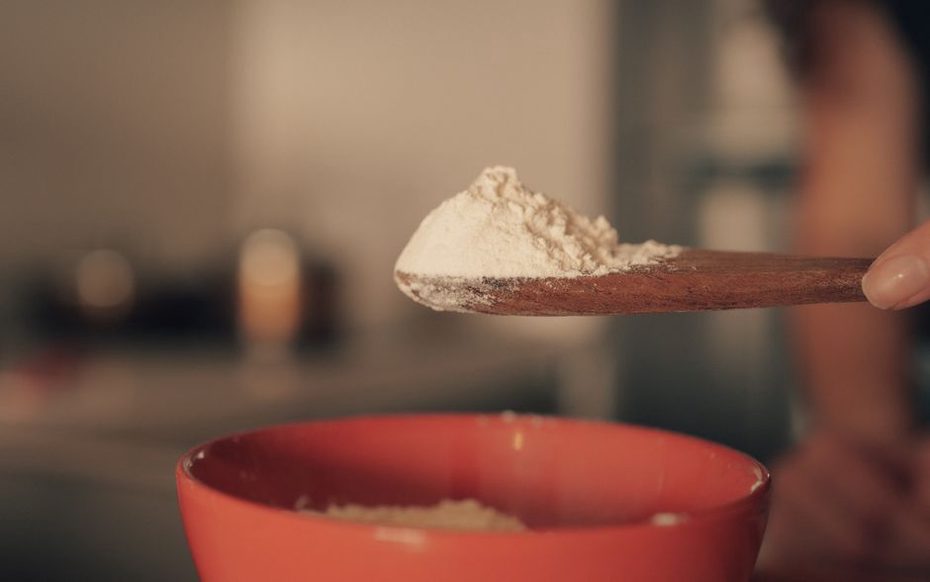 gelatin powder absorbing cold water in a ceramic bowl before mixing
