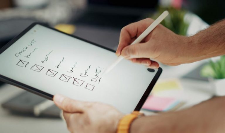 digital AIP guide on a tablet beside a paper elimination checklist