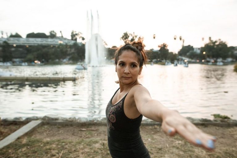 person stretching outdoors with relaxed posture