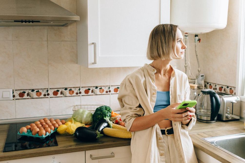 close-up of a person's uncertain expression over a meal of broccoli and eggs