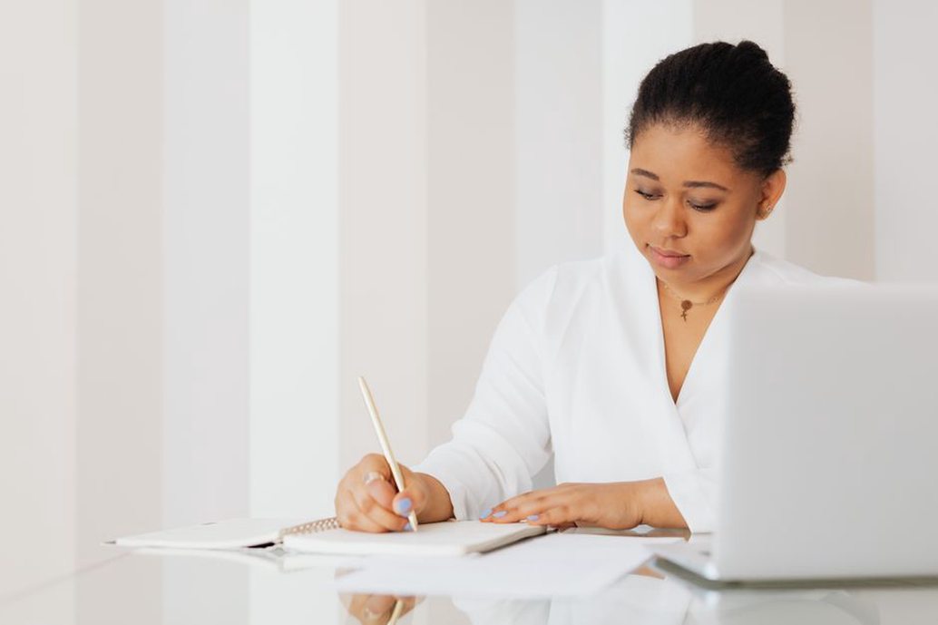 woman writing in food and symptom journal during an elimination diet