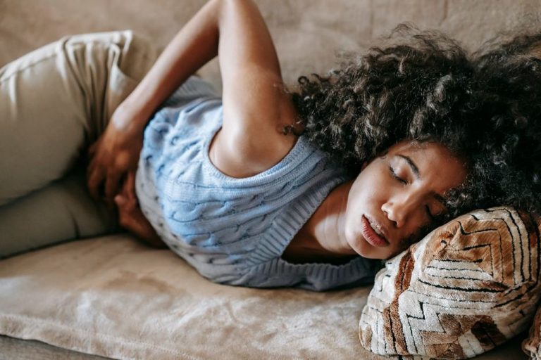 Woman experiencing ongoing bloating despite eating whole foods