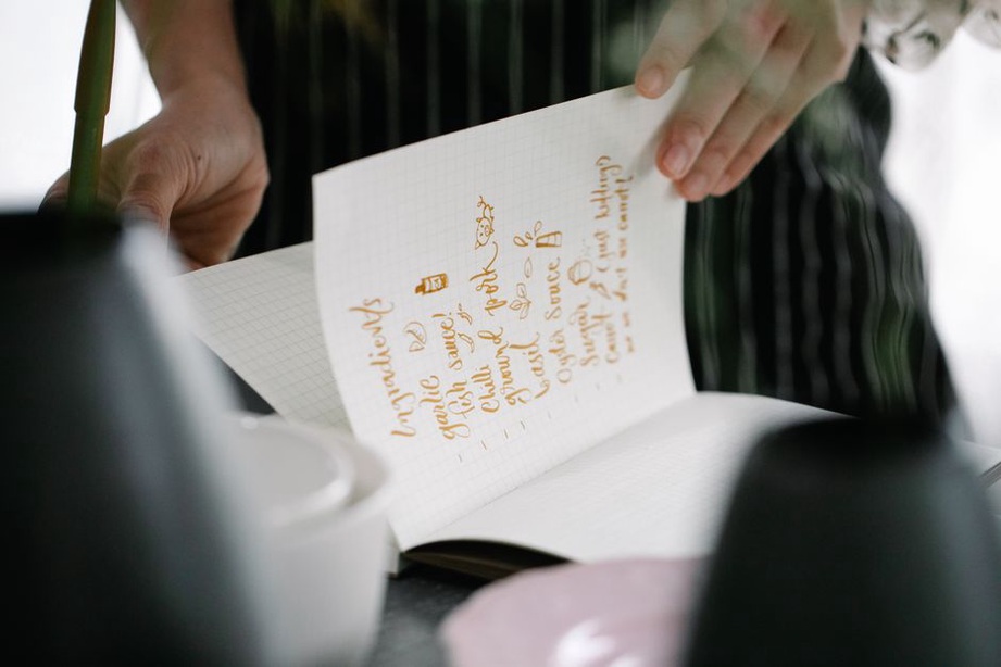 someone journaling meal reactions with a calm expression