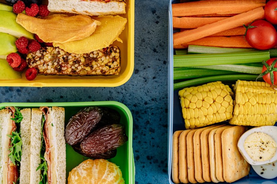 Packed snack box with chicken, fruit, and vegetables