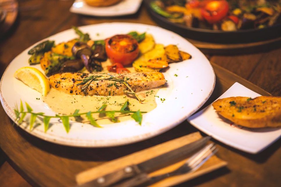 Roasted squash, greens, and salmon on a plate