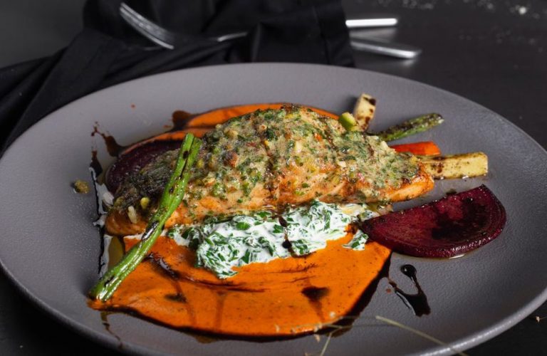 Salmon and sweet potato served with cooked vegetables