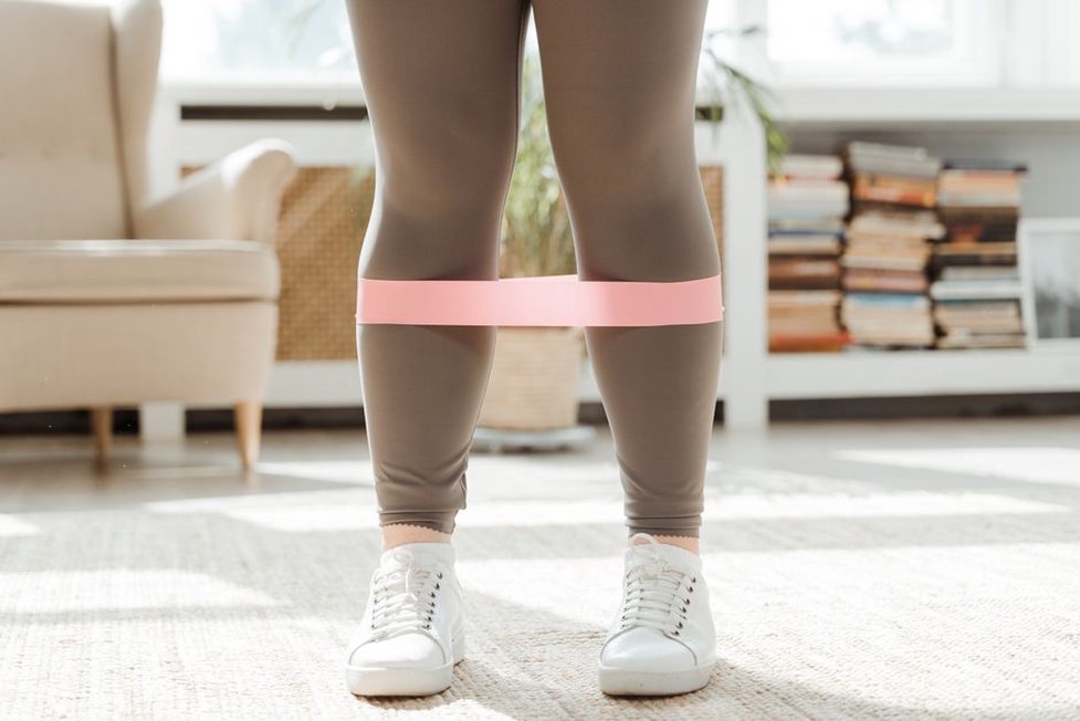 Resistance band exercise in a clear living room