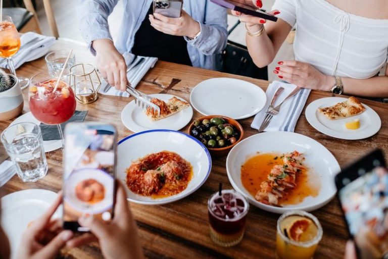 Friends passing dishes during a relaxed dinner