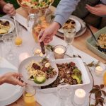 Friends share a meal with different food choices
