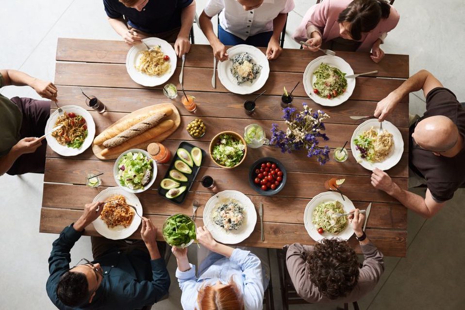 Friends enjoying dinner with varied plates