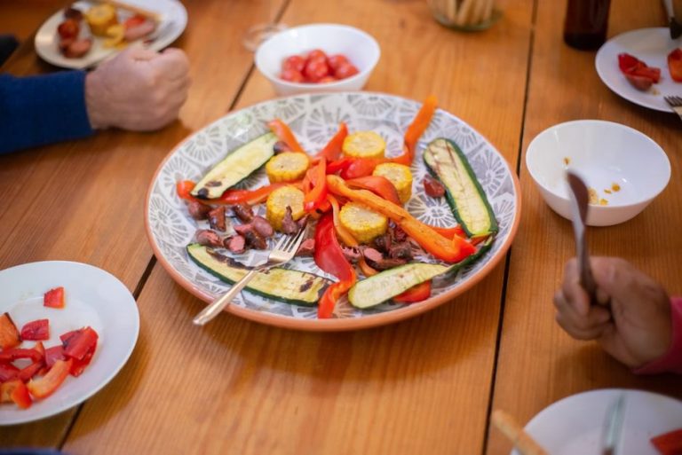 A shared table with simple roasted vegetables and protein