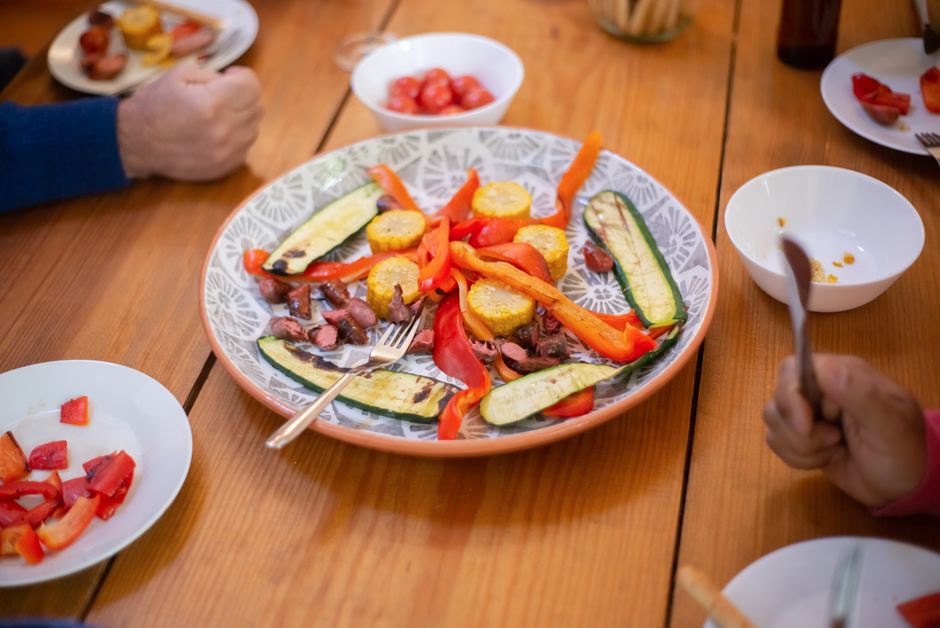 A shared table with simple roasted vegetables and protein
