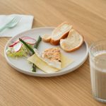 Meal notes beside a plate of vegetables and fish