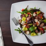 A balanced Paleo meal on a wooden table indicating an intermittent fasting routine