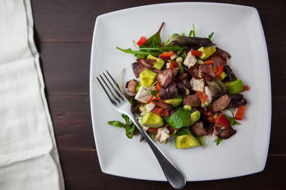 A balanced Paleo meal on a wooden table indicating an intermittent fasting routine