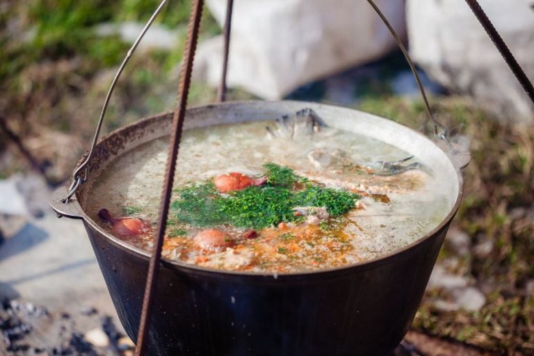 Warm broth served beside a pot of soup