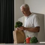 An older adult preparing a varied vegetable meal