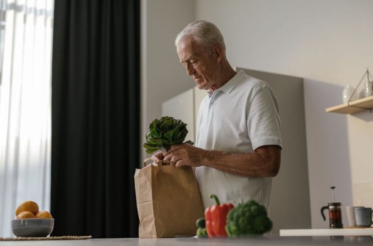 An older adult preparing a varied vegetable meal