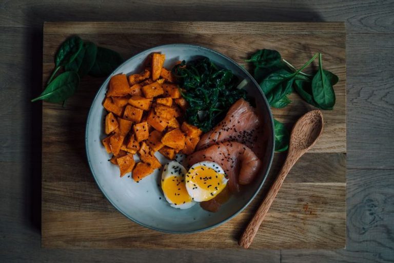 Salmon, sweet potato, and vegetables on a balanced plate