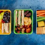 A packed snack box with eggs vegetables and berries