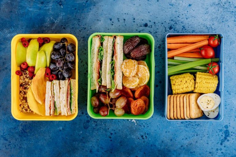 A packed snack box with eggs vegetables and berries