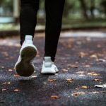 person jogging in a park with a smile