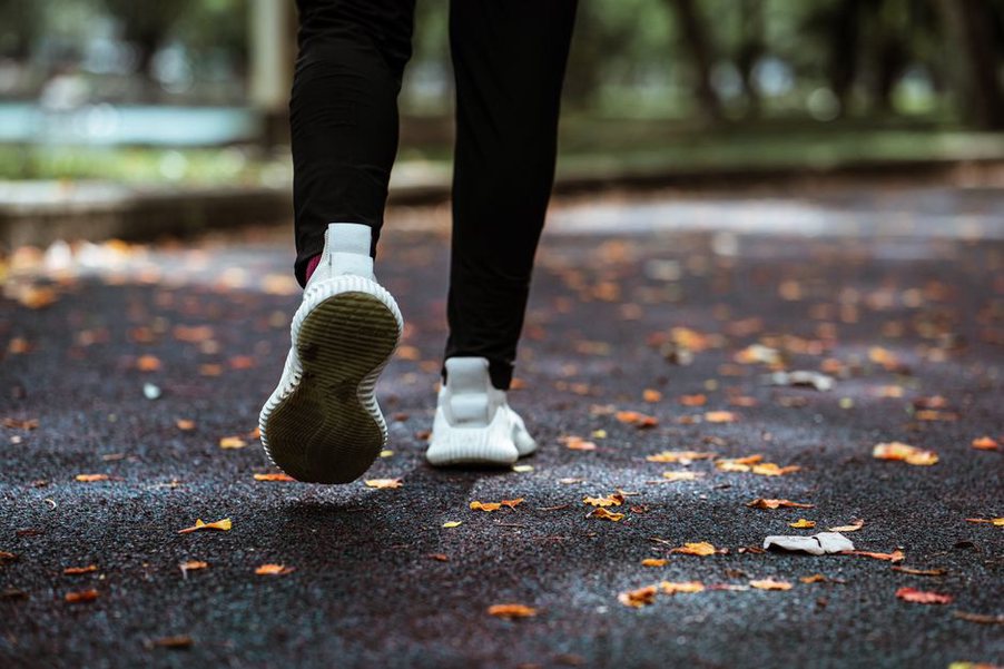 person jogging in a park with a smile