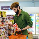 A shopper checking a long ingredient list
