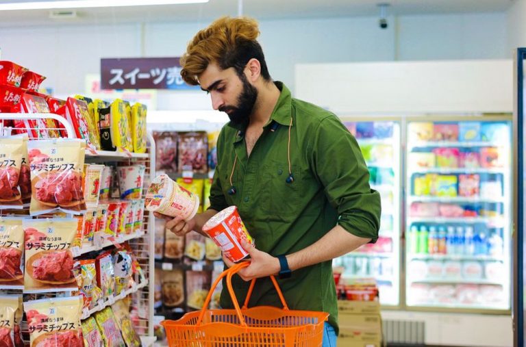 A shopper checking a long ingredient list