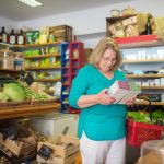 A shopper compares a detailed ingredient list