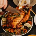 Roasted chicken served with carrots and sweet potatoes