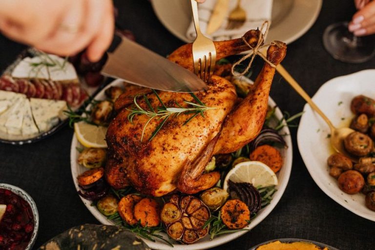 Roasted chicken served with carrots and sweet potatoes