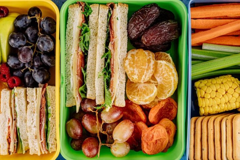 Packed travel foods beside a carry-on bag