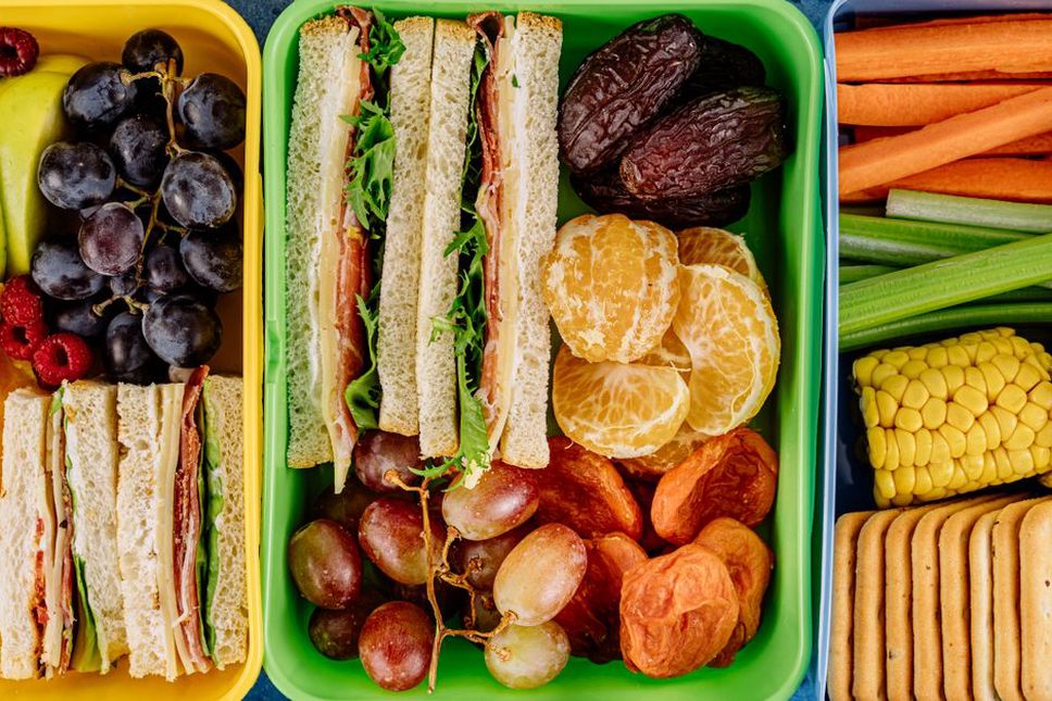 Packed travel foods beside a carry-on bag