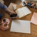 Two people compare dinner plans at the table