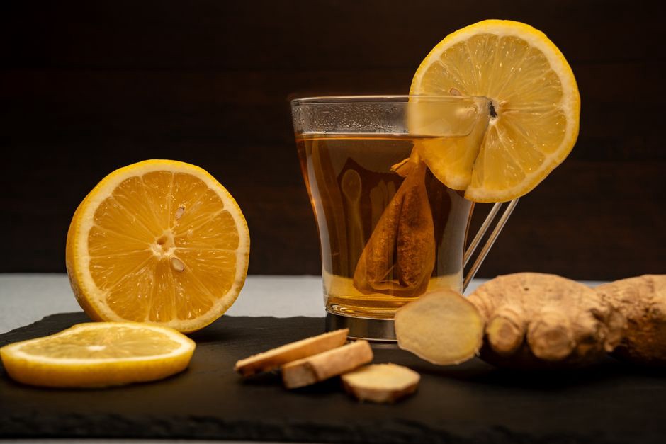 Ginger infusion cooling beside sliced citrus