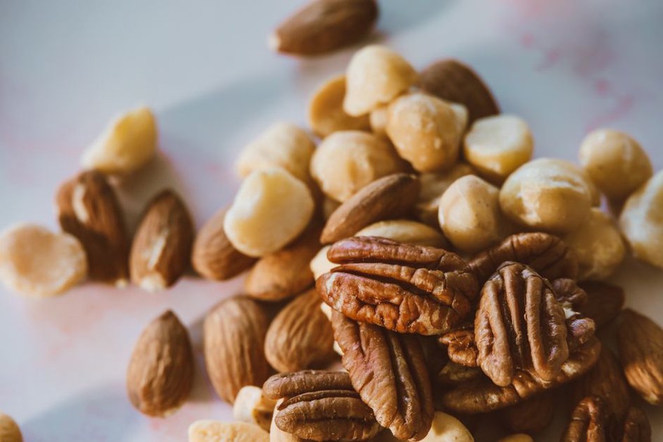 A selection of prepped paleo snacks including nuts, fruits, and jerky