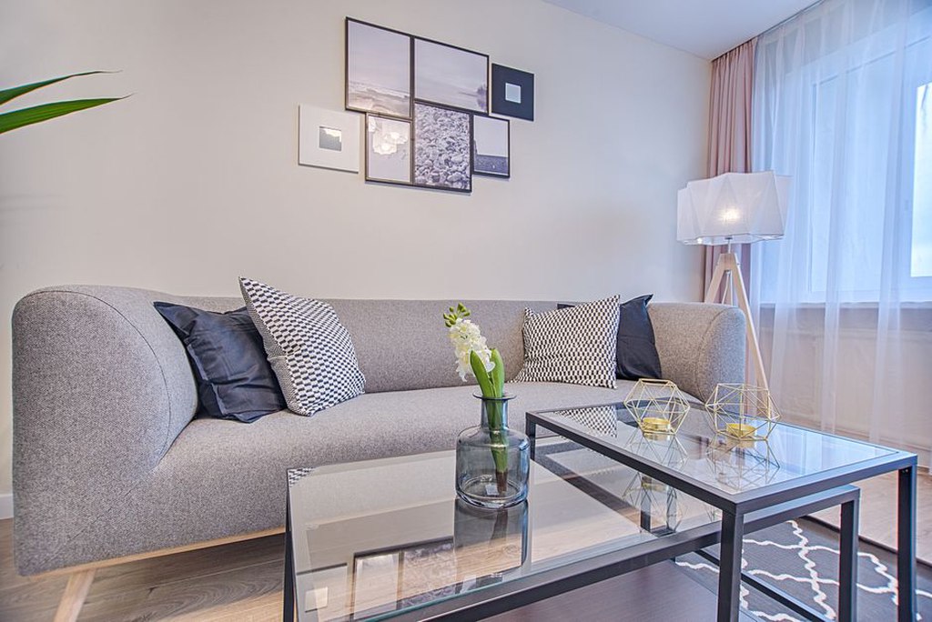 Framed prints and a warm lamp beside seating