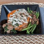 Cooked fish with vegetables and a starchy side