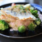 Fish served with a modest portion of cooked vegetables