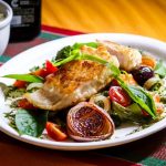 Roasted vegetables beside a balanced paleo meal